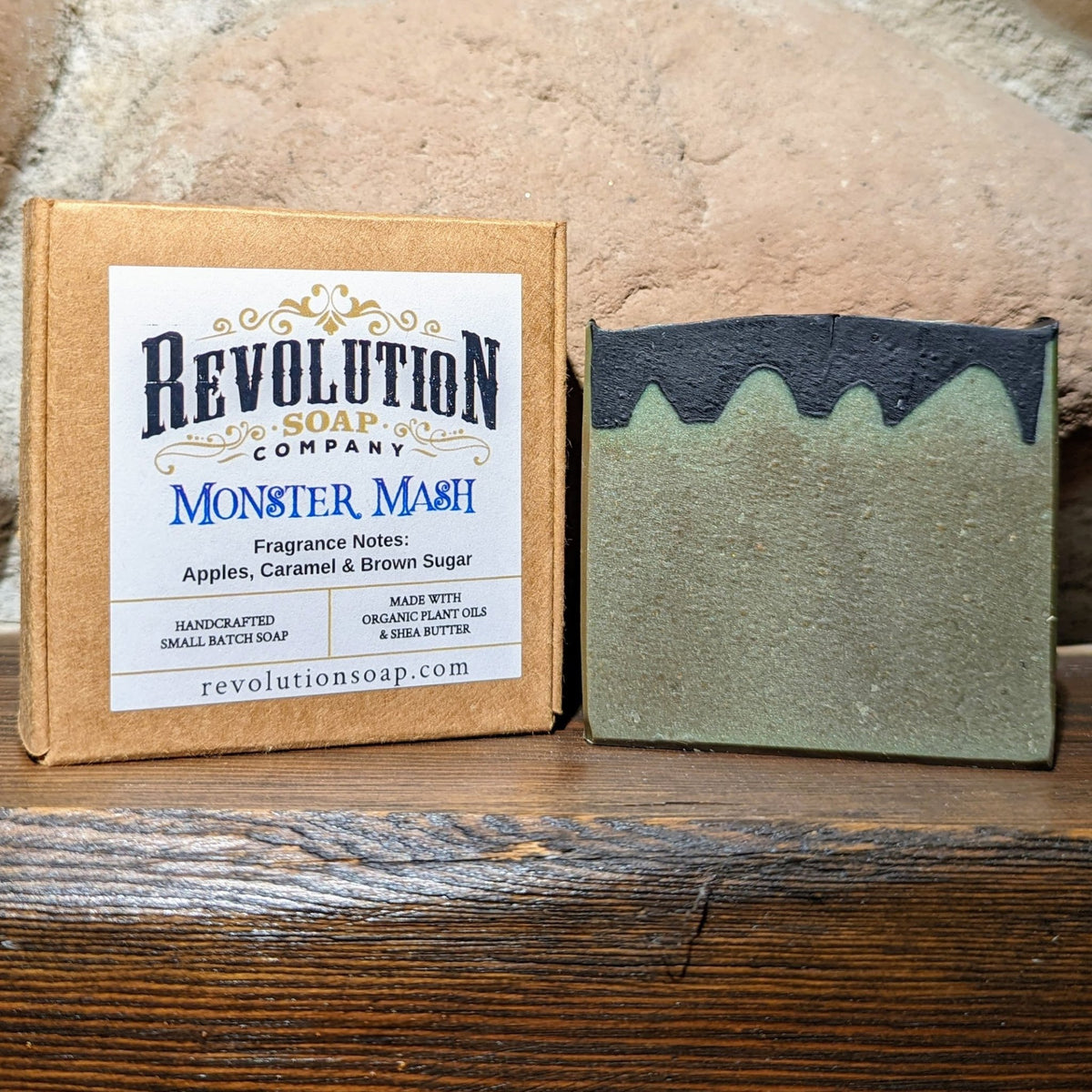 Soap bars with dark blue and green blocks, shown with cardboard packaging